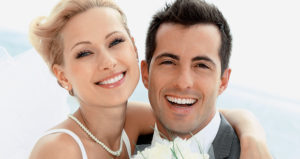 Newlyweds smile to reveal their bright white teeth